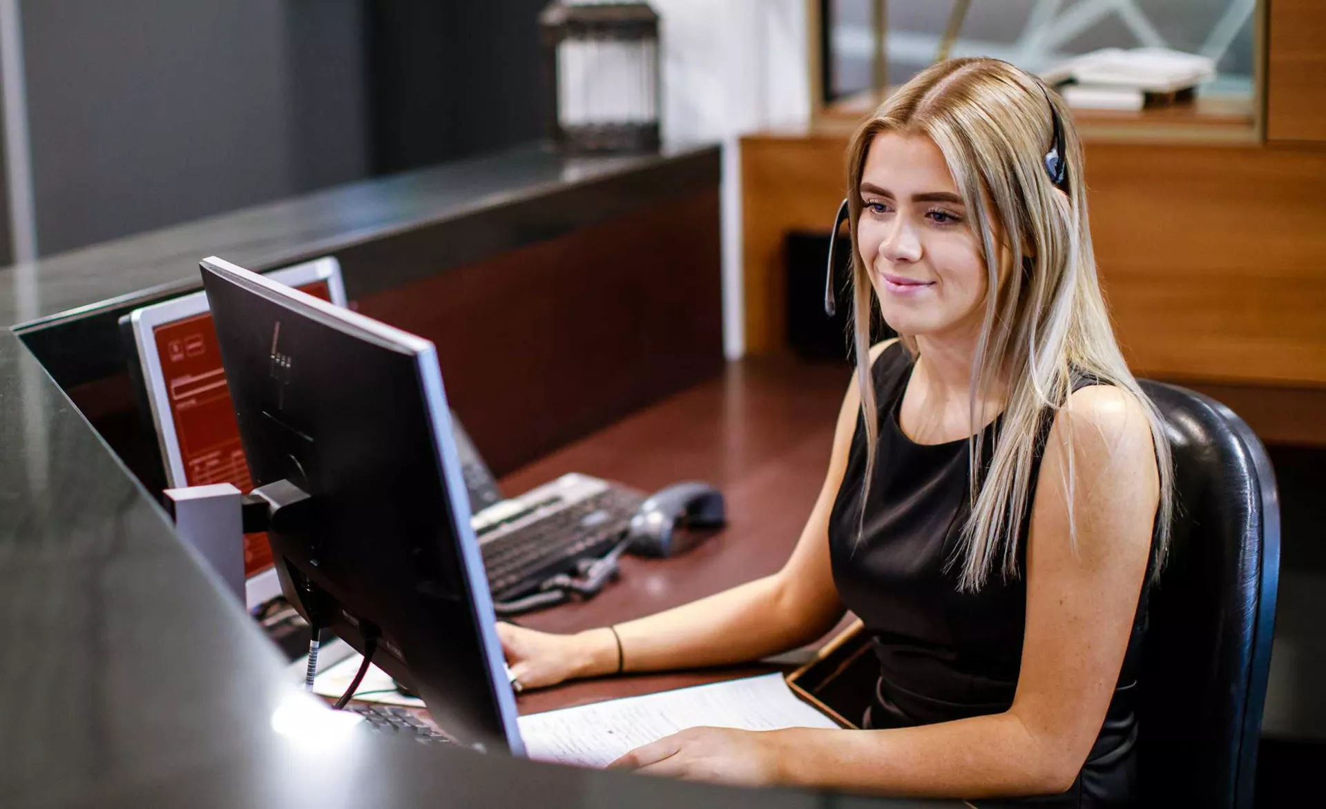 Receptionist helping clients at the front desk