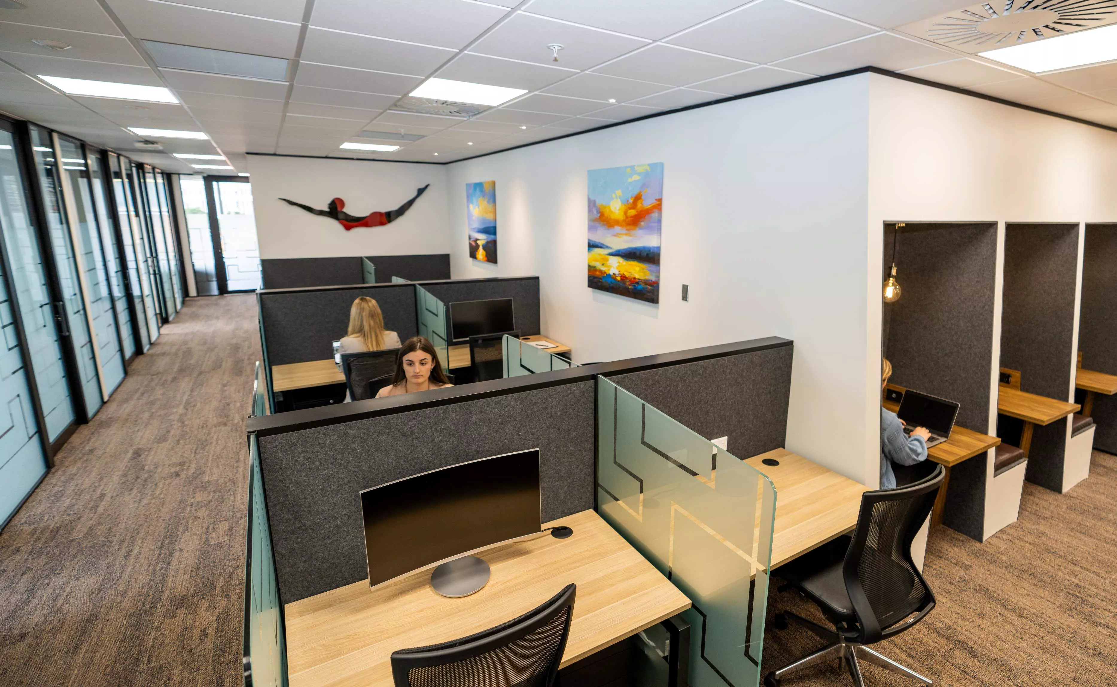 Clients working on dedicated desks in Servcorp Bell Gully Building, Wellington
