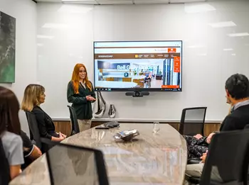 A client presenting and talking to her clients working in a modern boardroom space with the projection screen in Servcorp Bell Gully Building, Wellington