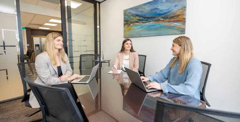 A client receiving IT help in a fully fitted serviced office in Servcorp Bell Gully Building, Wellington
