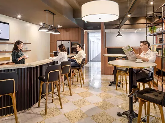 People enjoying their time in a modern fully stocked kitchen break room in Servcorp Avaya House, Macquarie Park